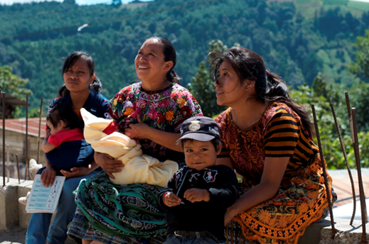 Mothers sit with their young children during a breastfeeding training at a local health center in Guatemala. Photo: Peace Corps Guatemala